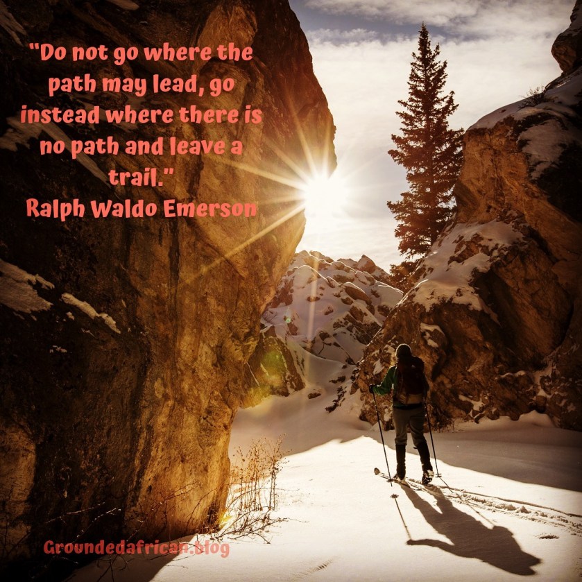 Man walking through snowy mountains leaving a trail of footprints. Quote by Ralph Waldo Emerson