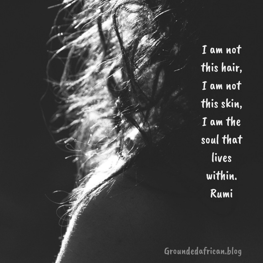 Backlight view of a woman’s should with wavy hair caught in the light