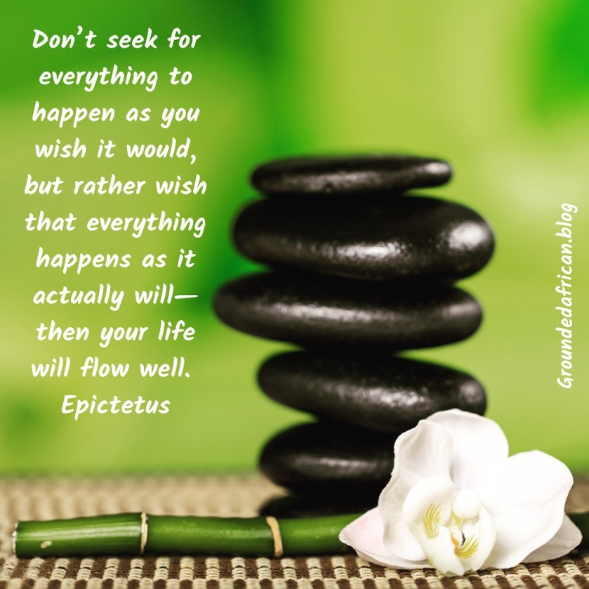 Balancing stones with bamboo stalk and flower. Quote by Epictetus 