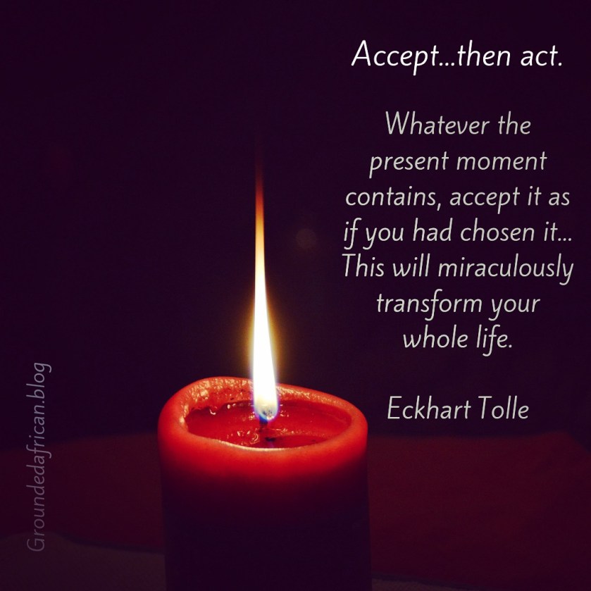 Red candle burning. Dark background. Quote by Eckhart Tolle 