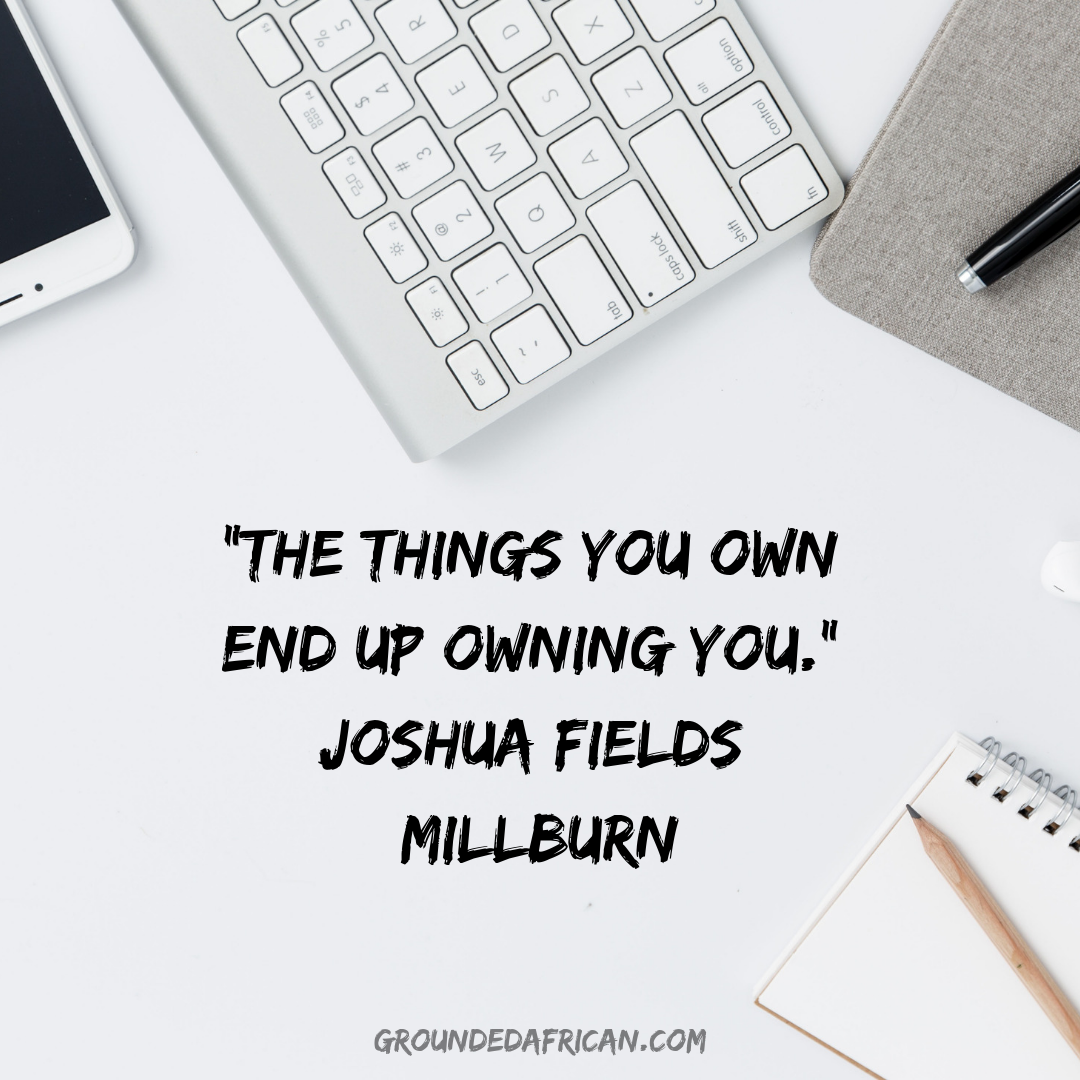 Electronic gadgets on a white table top surrounding a quote by Joshua Fields Millburn