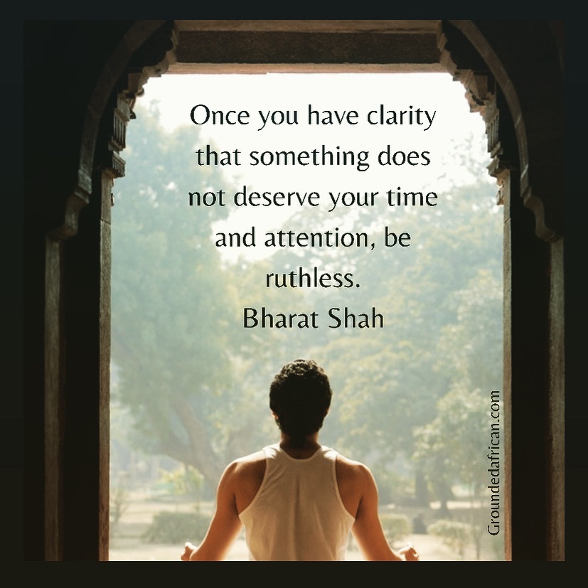 Man meditating in the doorway facing a forest. 