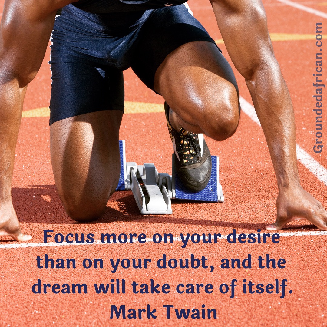 Male athlete in starting blocks. Quote re: focus by Mark Twain