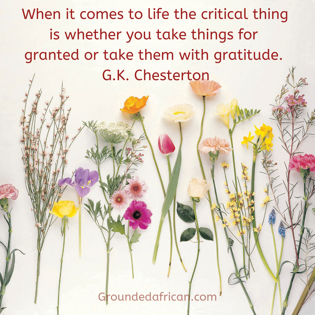 Flowers spread out on a white background. Quote by G.K. Chesterton