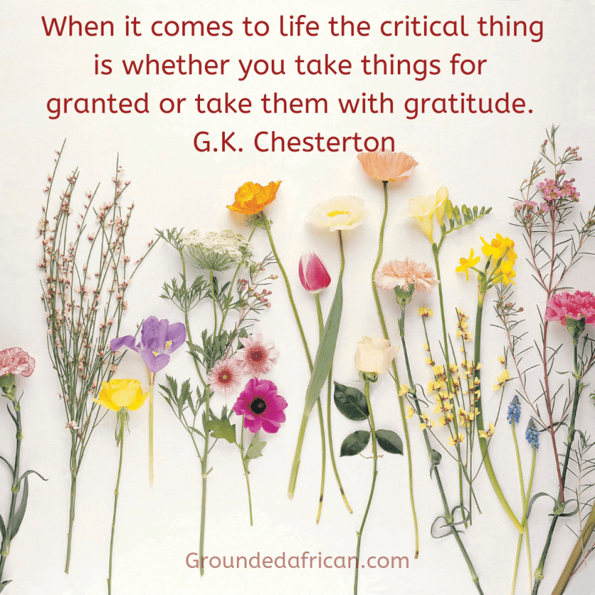 Flowers spread out on a white background. Quote by G.K. Chesterton