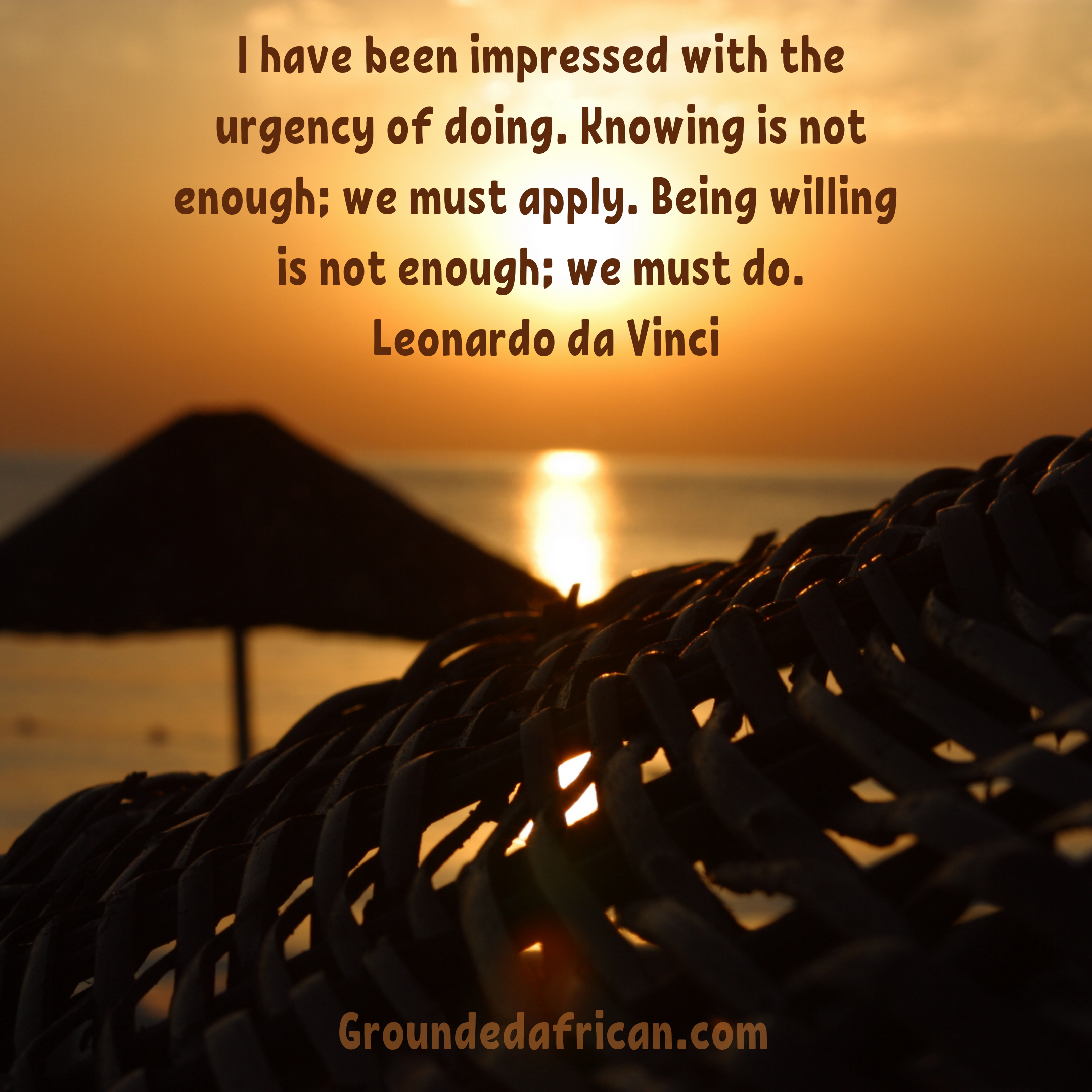 Sunrise over the sea. A beach hut silhouette in the foreground
