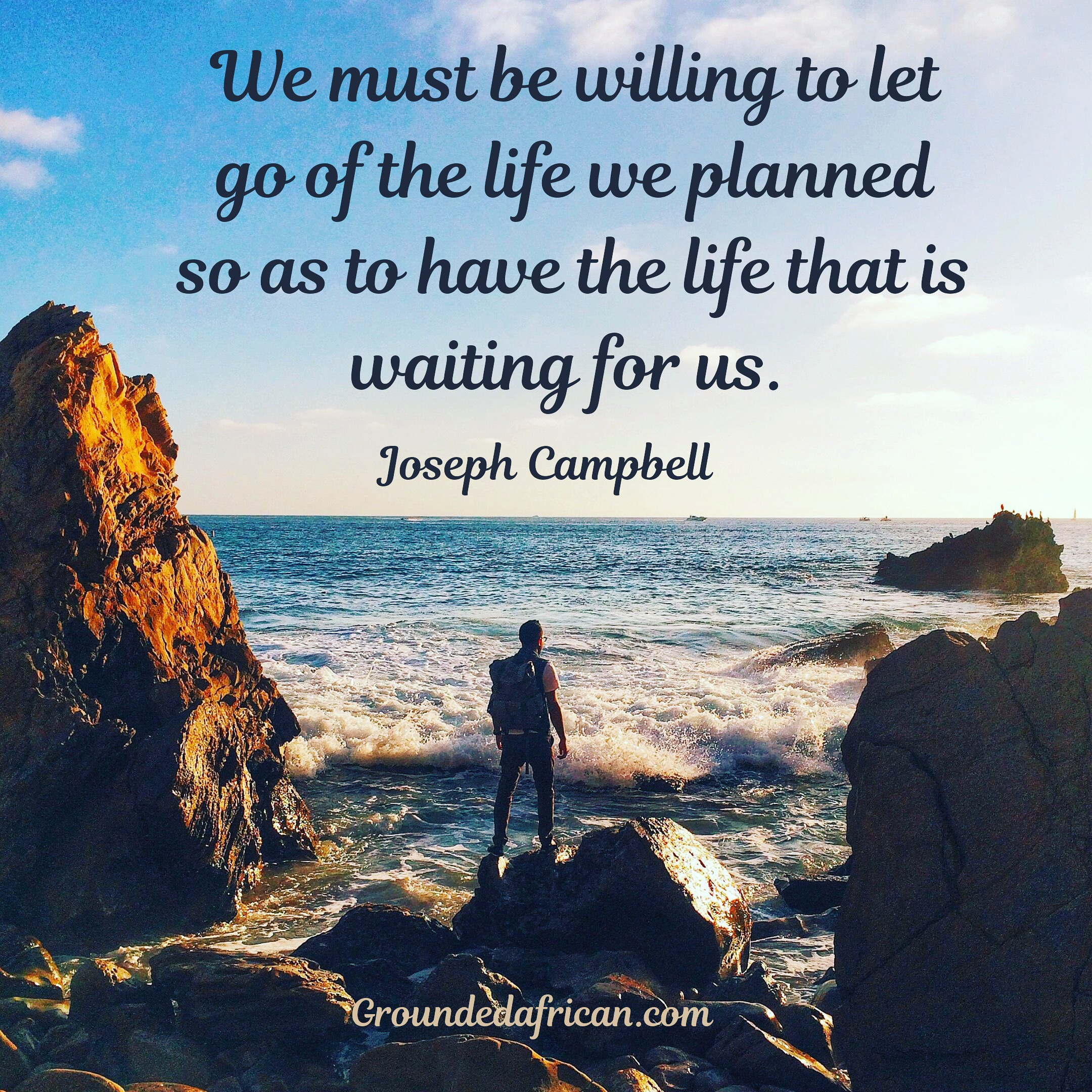Man on rocks between two large boulders at see