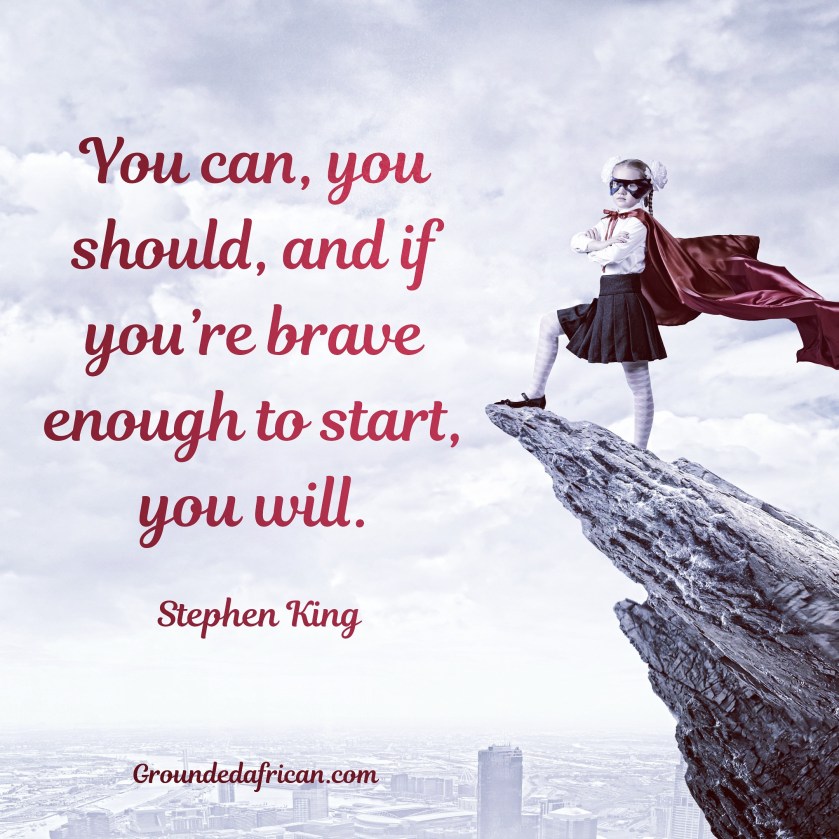 Girl in red cape and mask as superhero on ledge overlooking city