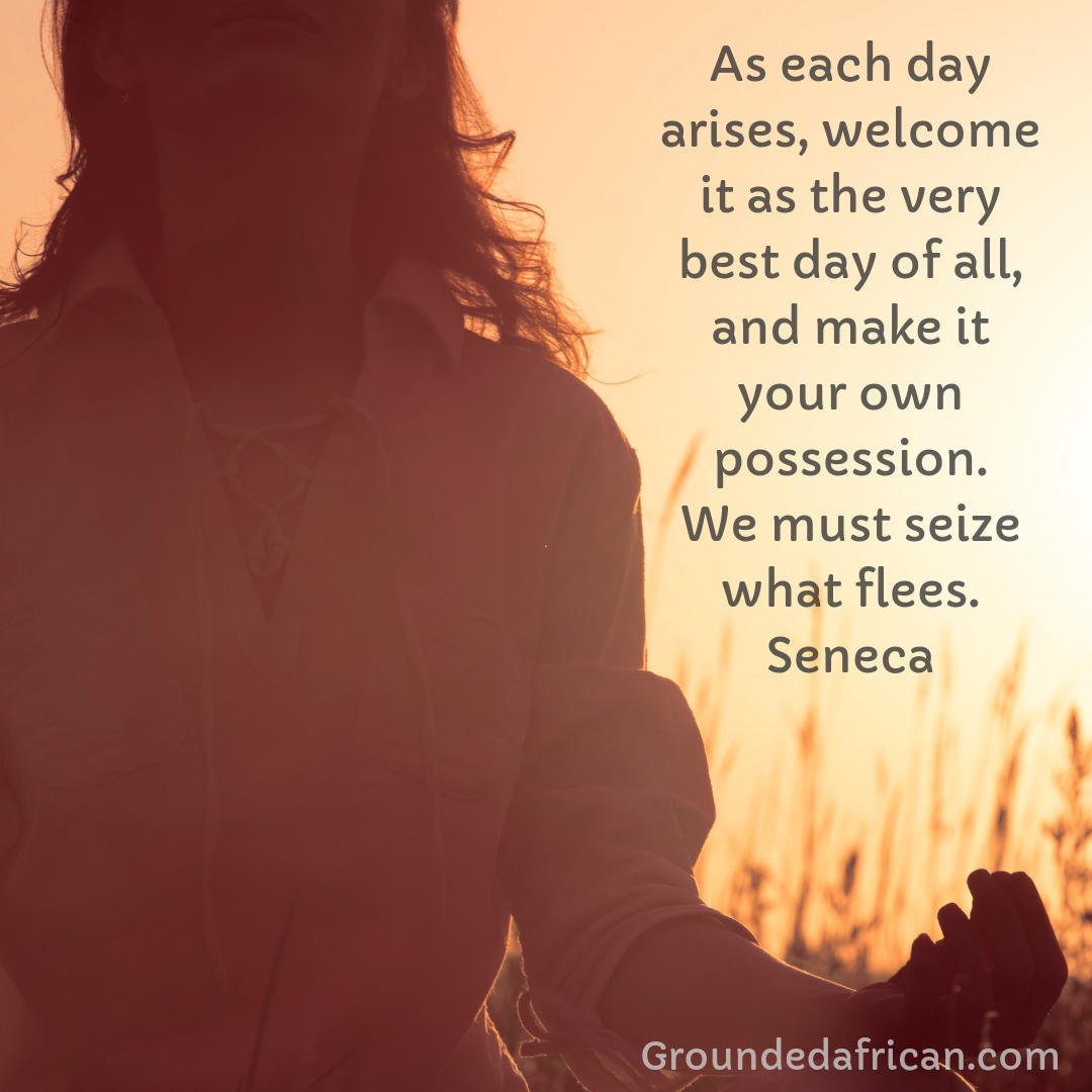 Lady meditating in the sunset in a field of long grass