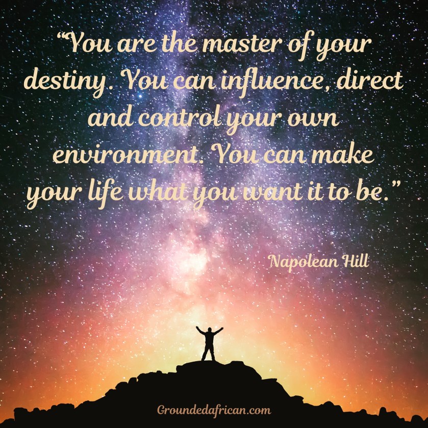 Man standing in victory stance looking at star filled night sky