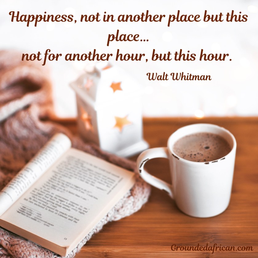 Mug of hot chocolate on table with book