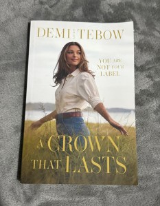 Book cover.  A woman in long grass